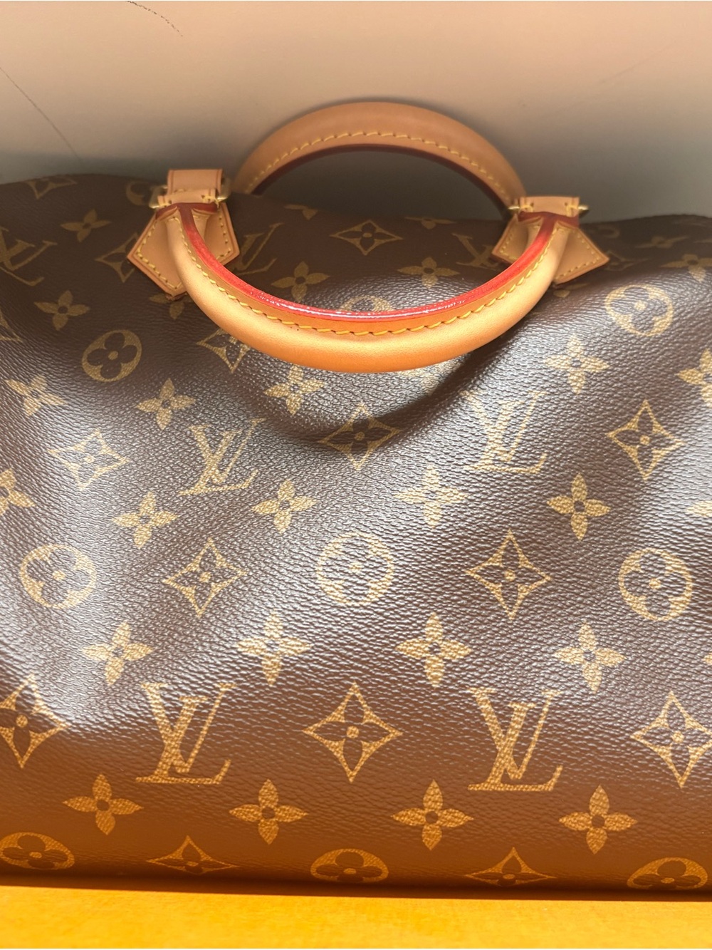 Louis Vuitton Monogram Travel Bag with Tan Handles and Red Edge.